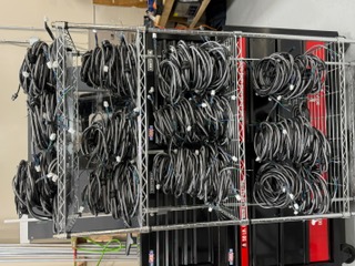 Shelves filled with completed wire harness assemblies bundled and ready for shipment